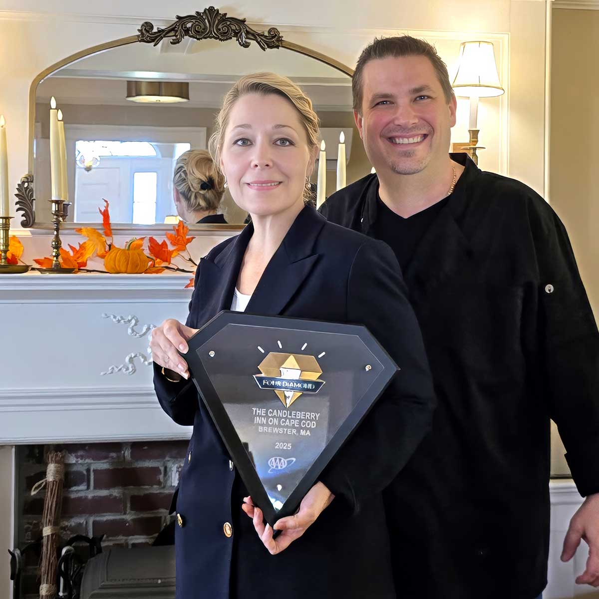 Innkeepers Charlene and Eric Taubert hold the AAA Four Diamond Award at Candleberry Inn on Cape Cod 